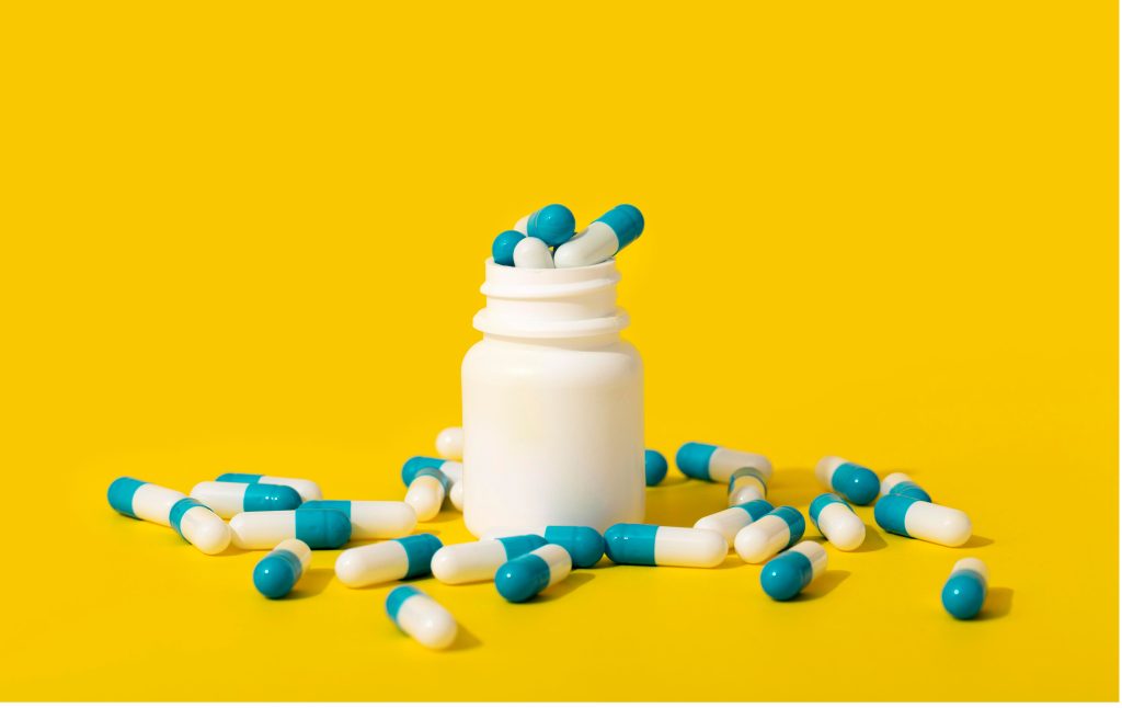 a bottle of pills representing medical care for urinary urgency. 