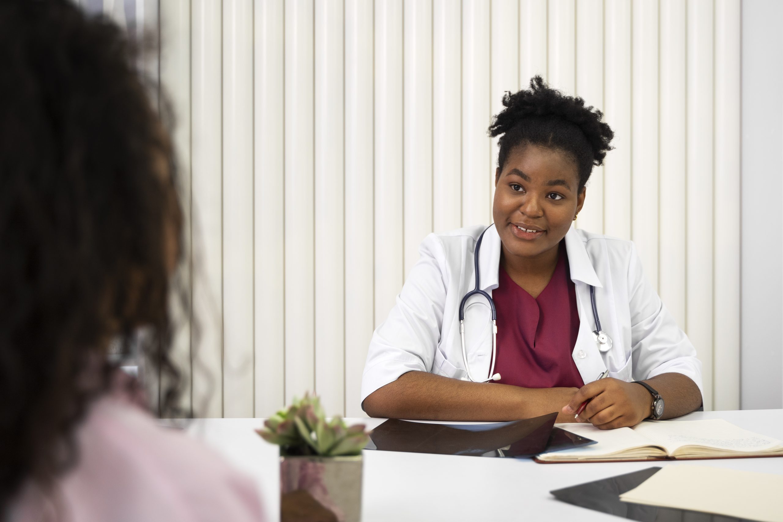 a doctor asking a patient about her pelvic floor health.
