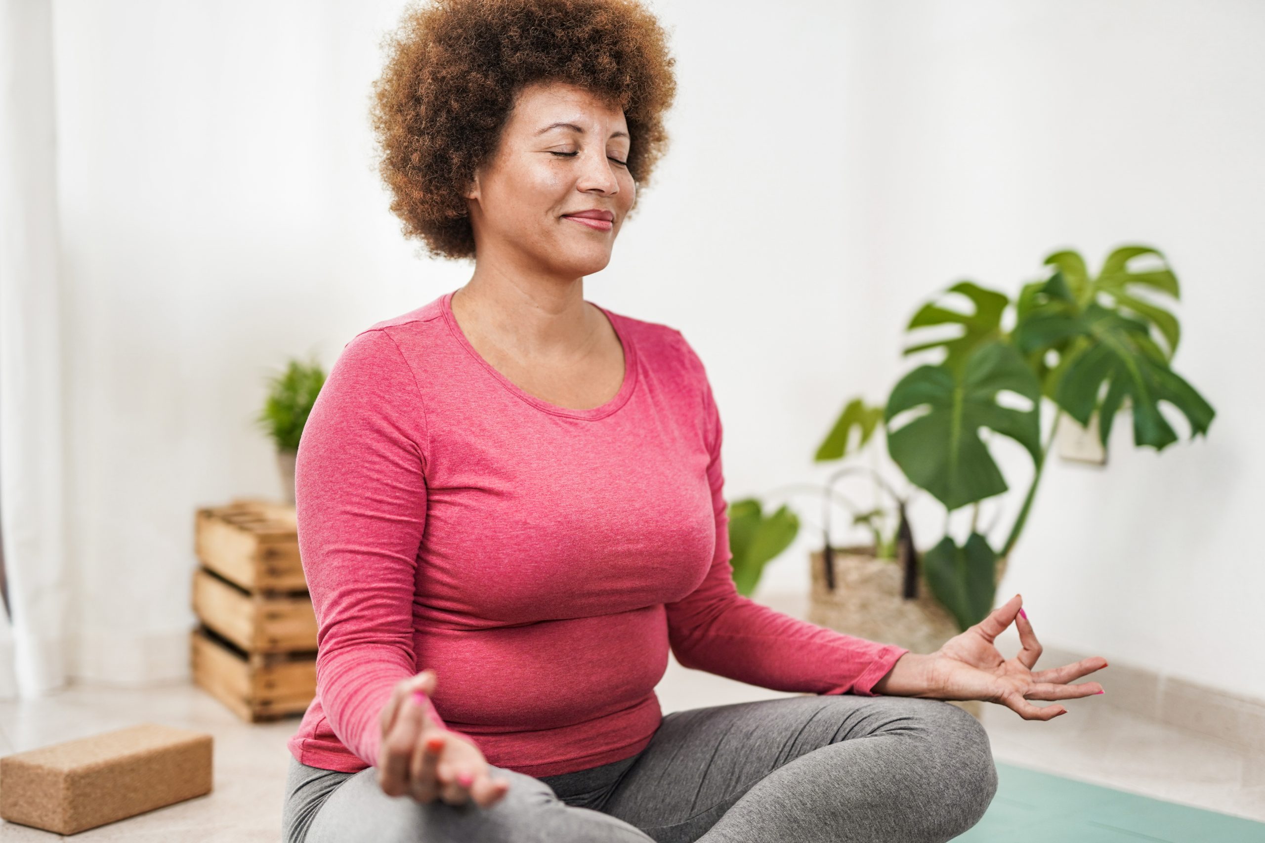 African American senior woman practicing mindfulness to help with her urinary difficulties. 